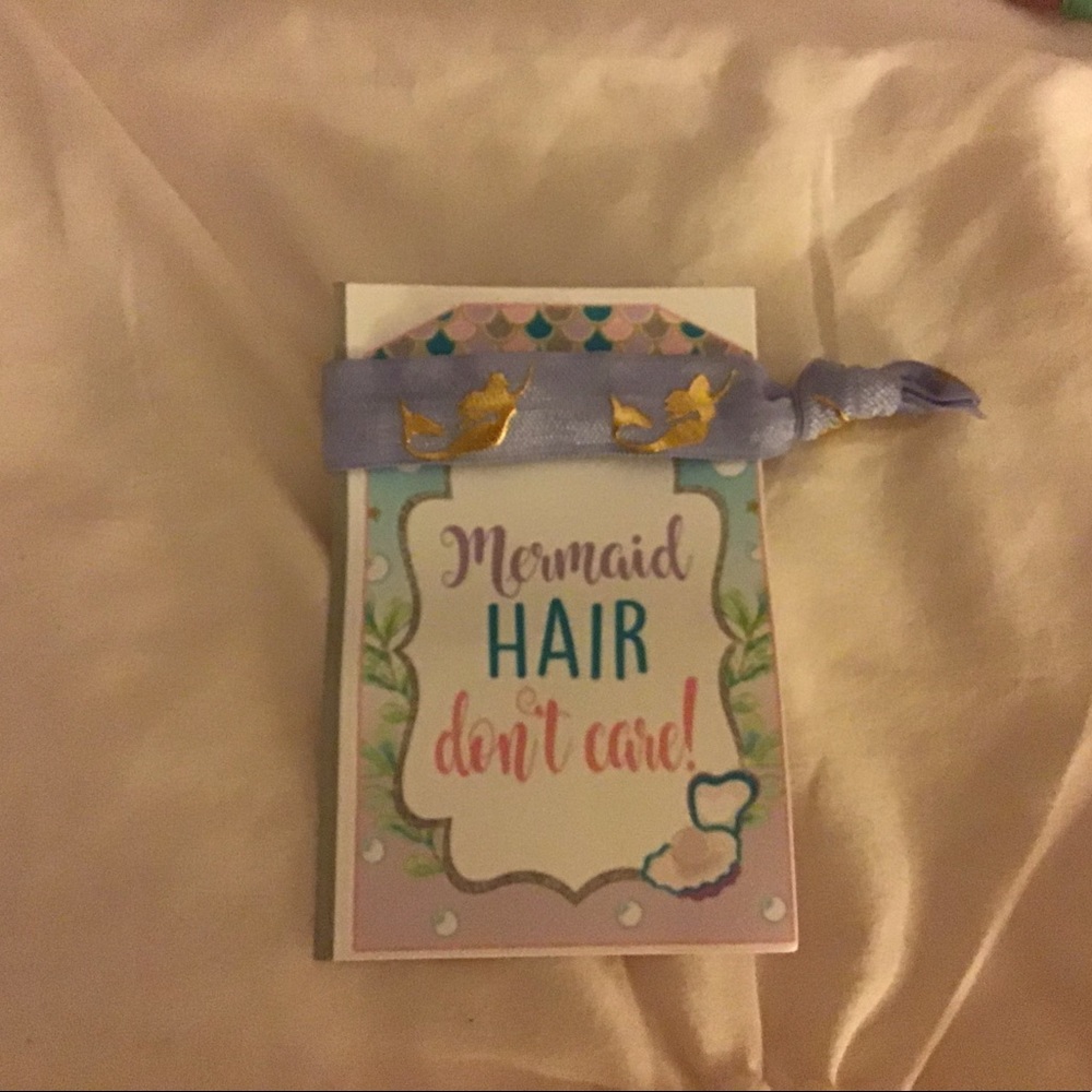 One is purple and the other is a bluish green and it has gold mermaids on it